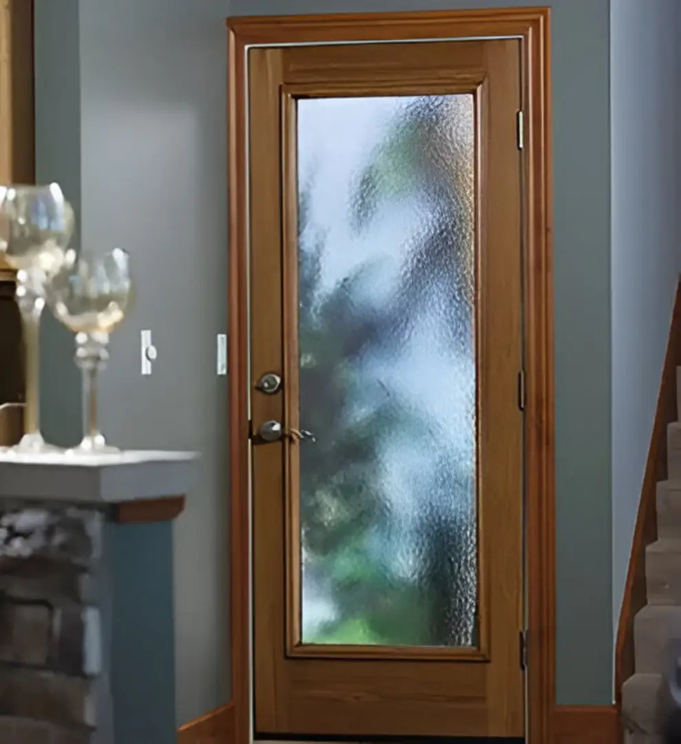 Wooden door featuring glass panels on the inside, showcasing a blend of natural and transparent elements.