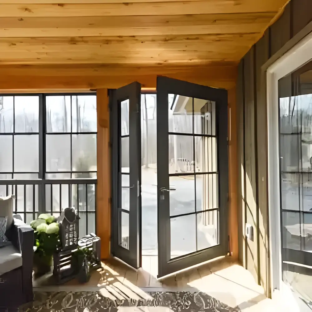 A welcoming porch with WeatherMaster™ Doors and comfortable wicker chairs, perfect for enjoying the outdoors.